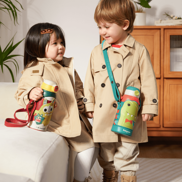 About us babycare wher etow kids are standing next to each other smiling and two best water bottles in UAE at affordable price and premium quality